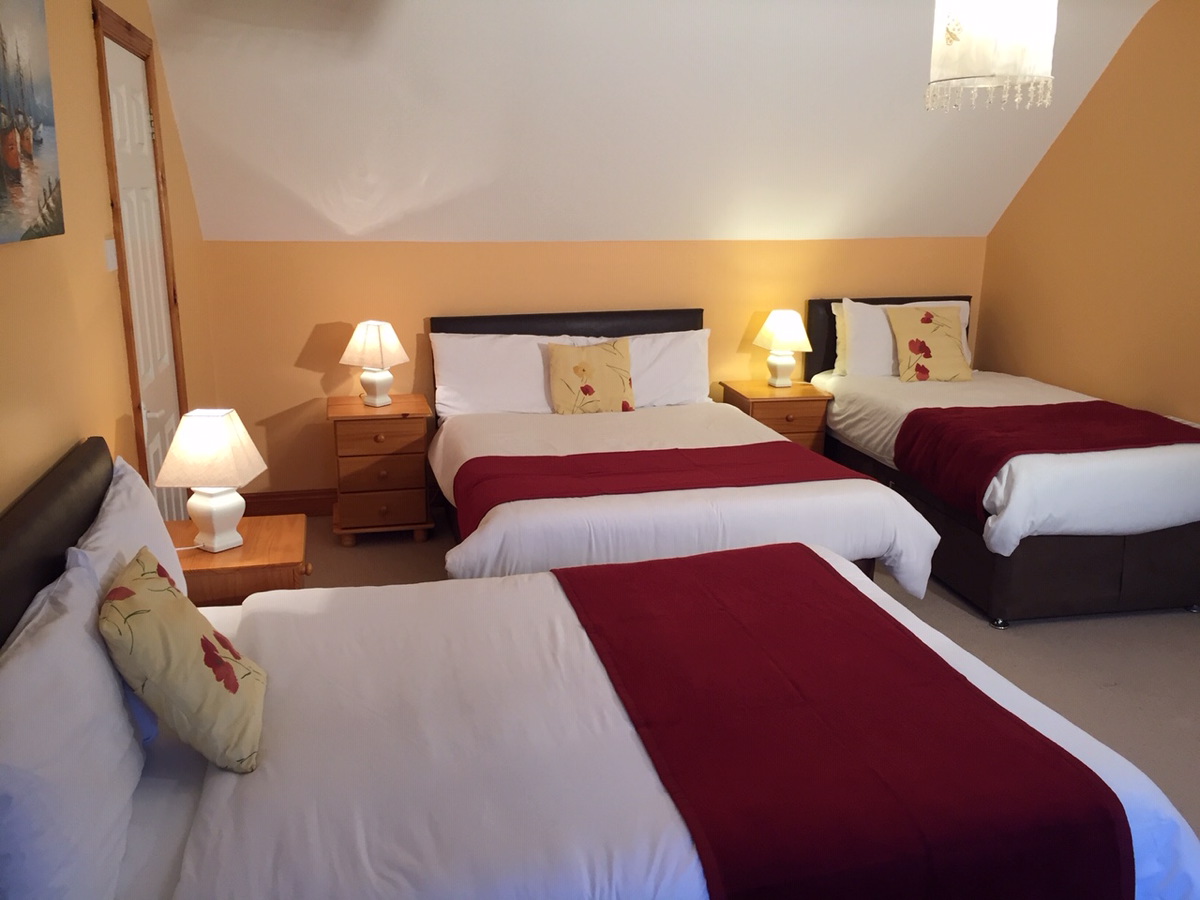 Spacious family bedroom with double and single beds